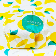 画像をギャラリービューアに読み込む, A sea sponge in bright yellow and green packaging against a patterned background
